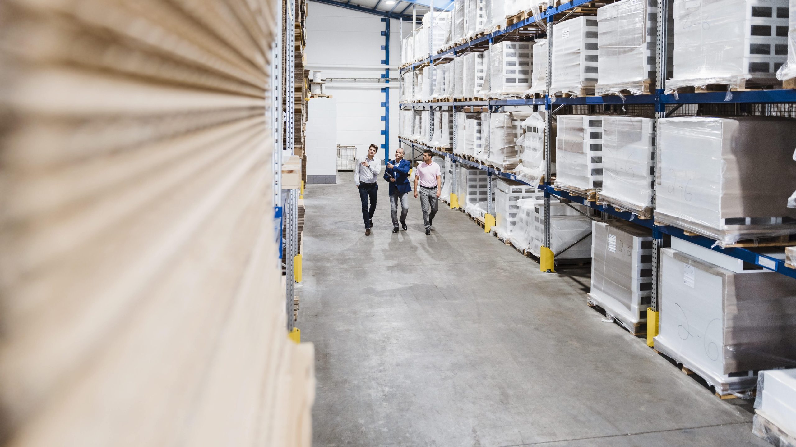 Warehouse employees conducting an inspection in a well-organized storage facility in the US, showcasing Stellar Logistix's warehousing solutions.