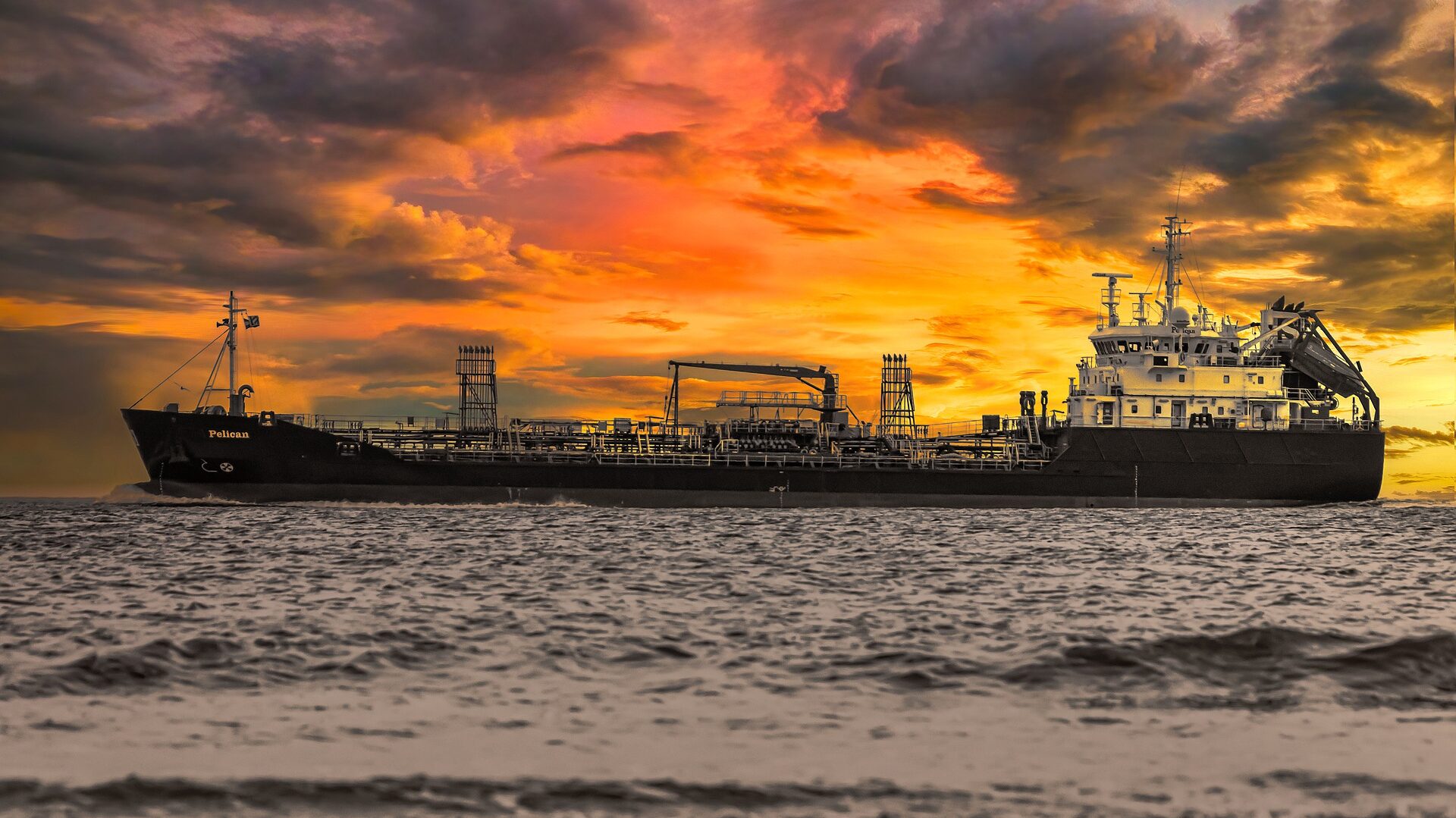 Cargo ship at sea under a vibrant sunset, illustrating international logistics services, a key component of what logistics services are.