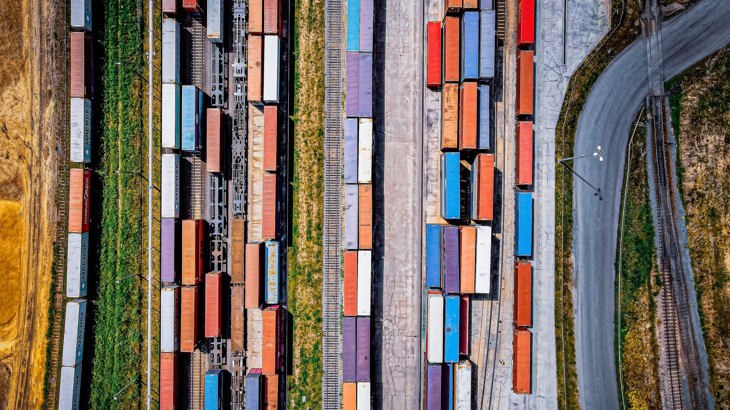 Top view of colorful freight trains on a railway, representing 3PL cross-border logistics solutions for efficient transportation.