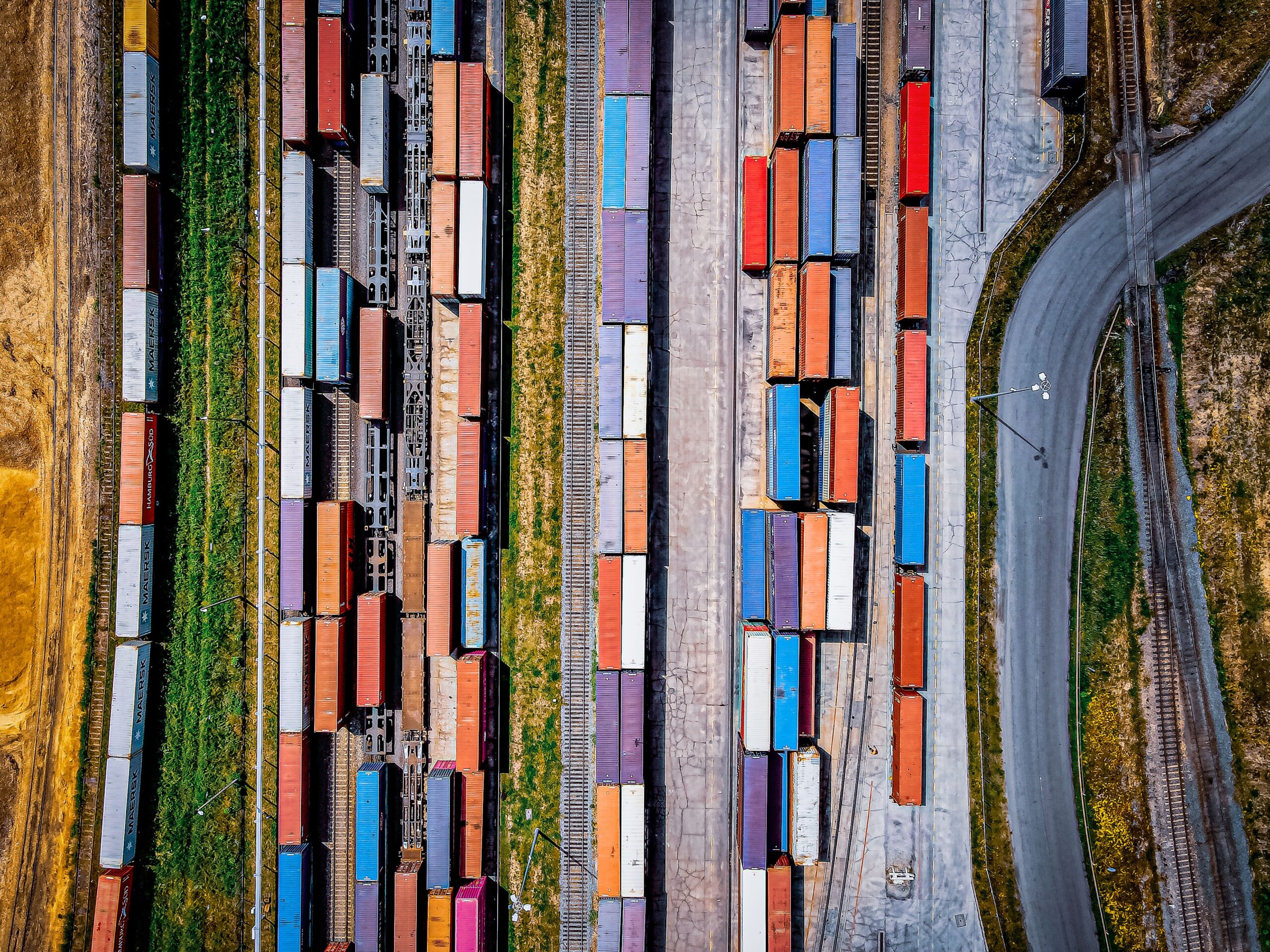 Top view of colorful freight trains on a railway, representing 3PL cross-border logistics solutions for efficient transportation.