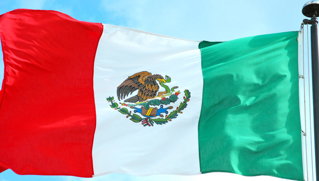 Mexico flag representing the rise in Mexico cargo theft and its impact on logistics and security.